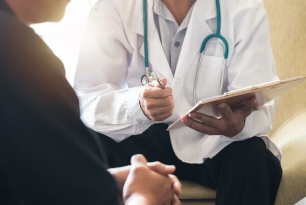 Men's health exam with doctor or psychiatrist working with patient having consultation on diagnostic examination on male disease or mental illness in medical clinic or hospital mental health service