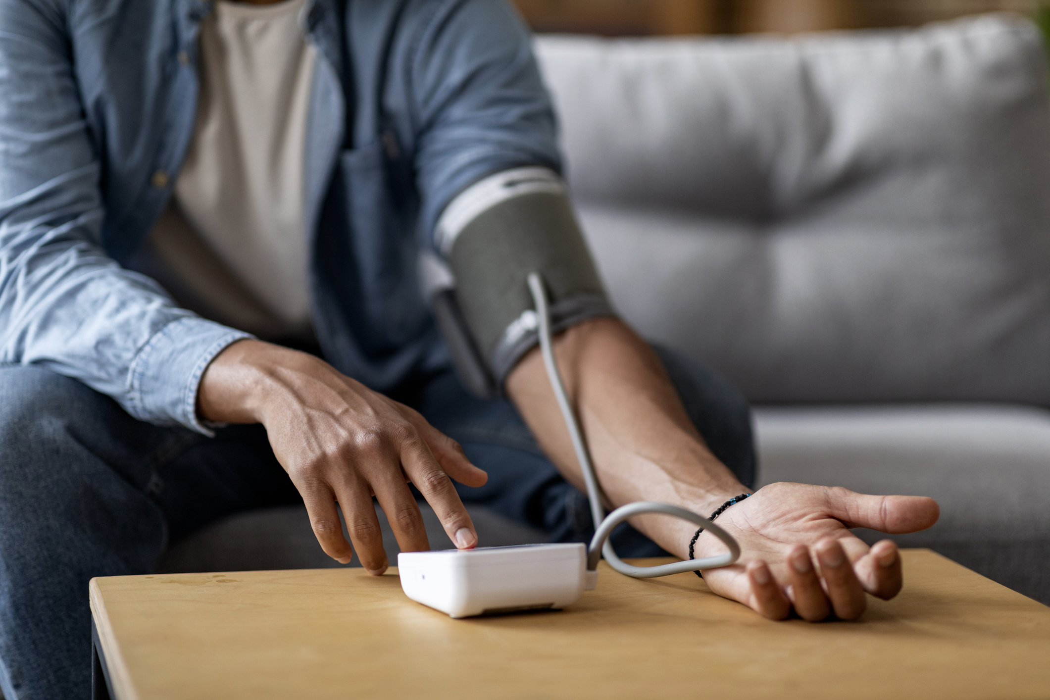 Cropped Of Young Black Man Checking Blood Pressure With Upper Arm Monitor