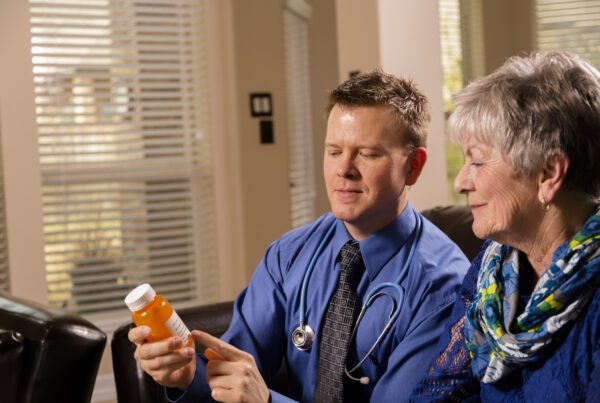Healthcare: Concierge doctor visits senior woman at home.